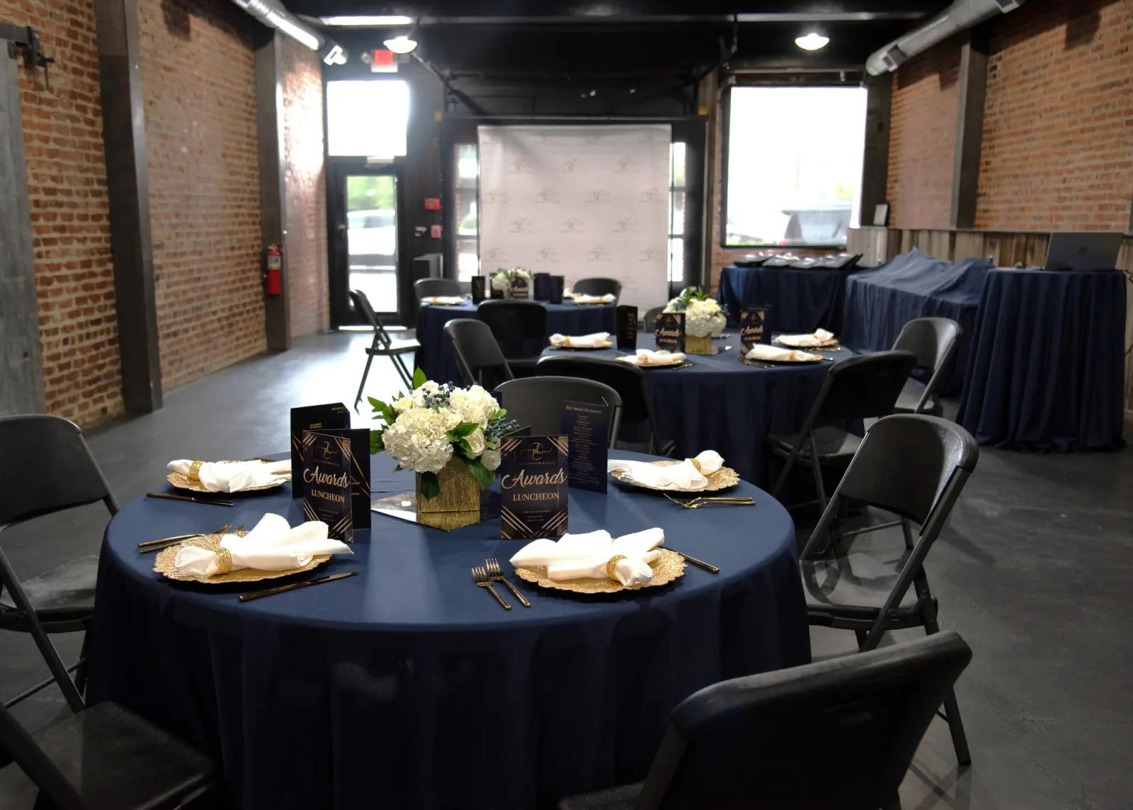 Corporate awards luncheon with navy linens and gold place settings
