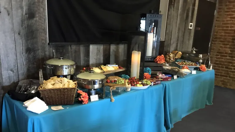 Catered buffet with chafing dishes and a fruit display