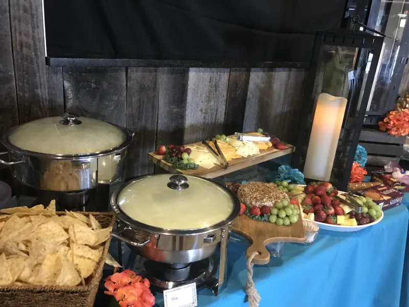 Buffet spread with a cheese and fruit board