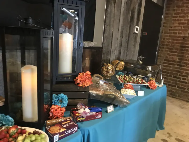 Appetizer table with candles and floral accents