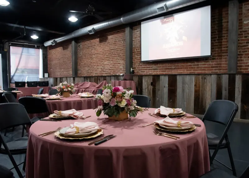 Awards luncheon with mauve linens and a projector screen