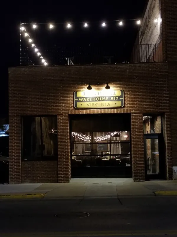 Warehouse 817 entrance and lit sign at night