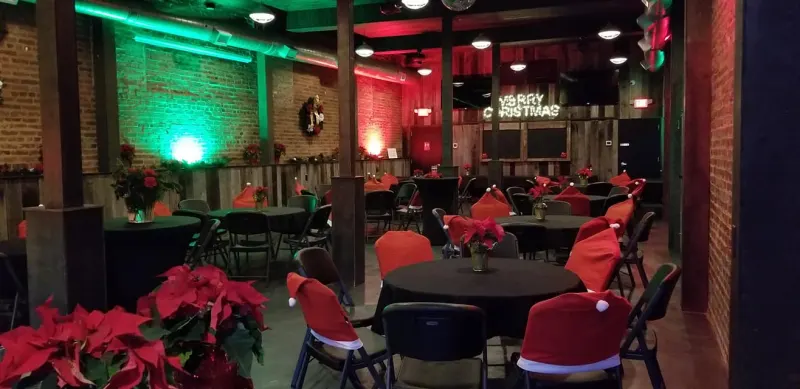 Holiday tables with Santa-hat chair covers and poinsettias