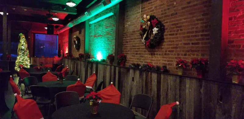Holiday wreaths and poinsettias along the brick wall