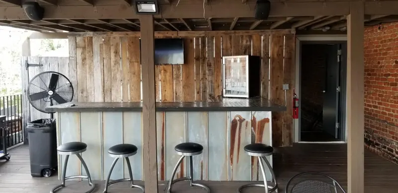 Rustic rooftop bar built from reclaimed wood and metal