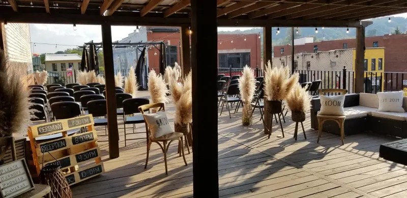 Boho rooftop ceremony at golden hour with pampas grass