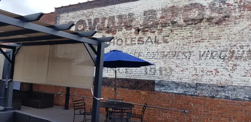 Rooftop deck beside the historic Cowan Bros. ghost sign
