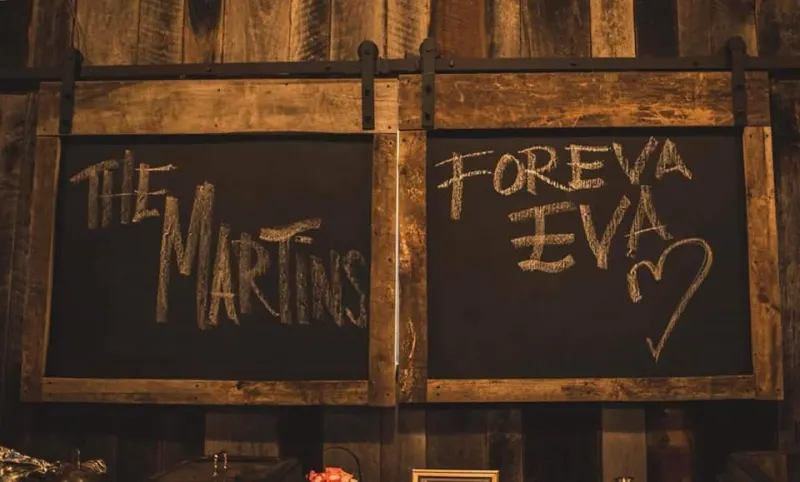 Chalkboard signs reading 'The Martins - Foreva Eva'