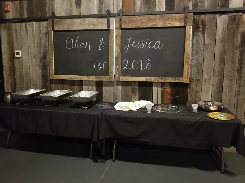 Buffet table with chalkboard signs for Ethan and Jessica
