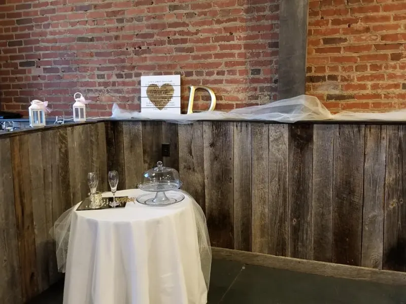 Cake display table against the exposed brick wall
